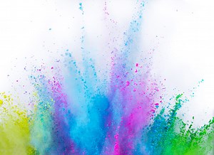 Multi colored powder explosion isolated on white background. Freeze...