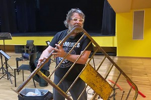 Musician amazingly converts a metal street barricade into a flute