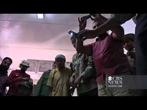 GRAPHIC VIDEO: Qaddafi's body on display in cooler