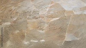 Transforming stone tile texture showcases a striking shift from grey to orange, highlighting the dynamic interplay of color Stock Video