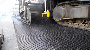 Special machinery making road in countryside area. Compactor constructing highway. Heavy machinery repairing road. Slowly driving roller laying new asphalt layer. Roadwork process. Roadway repair