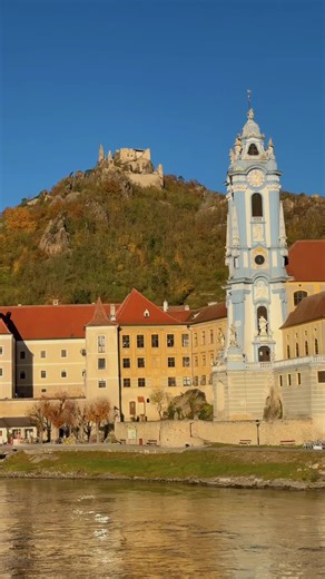 Scenic sailing on the Danube. Much like the Rhine, there are exceptional sequences of the river Danube. Fall foliage accents the castles, quaint towns, and churches as you sail down the river. #danuberivercruise #danube #traveltok #castles