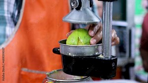manual orange squeezer machine. Orange juice traders squeeze oranges using a press machine. manual hand press juicer.