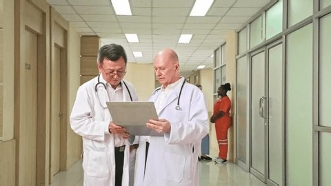 clip-4011177995-two-doctors-white-coats-review-patient-chart