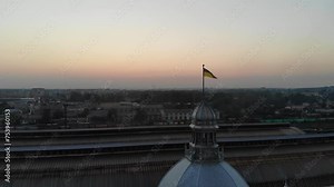 Experience the patriotic pride and architectural grandeur of Lviv's railway station in this captivating drone footage. As the Ukrainian flag billows majestically in the breeze, the station stands as