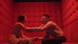 Playful drunk couple making out at party in night club, passionate...