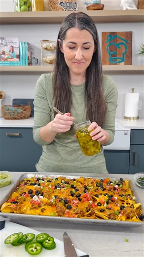 The ultimate nacho recipe! Crispy chips with melted cheese, ground beef, refried beans, and all of your favorite toppings. https://thestayathomechef.com/ultimate-nacho-recipe/ | The Stay At Home Chef