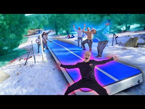 Friends ride world's biggest inflatable sled down steep hill