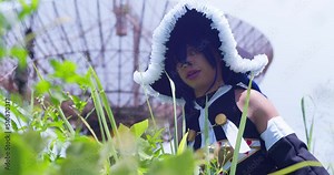 Descending reveal of a Wendy Belserion cosplayer in a large overgrown grass field with a radio tower in the background