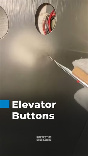 Technician drills precise holes for elevator buttons, showcasing technical expertise, precision, and seamless installation skills. | Interesting Engineering