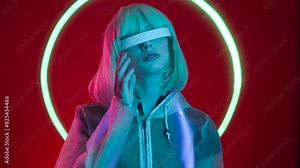 Woman in futuristic costume. Female in modern VR glasses interacting with network while having virtual reality experience. Augmented reality game, future technology.