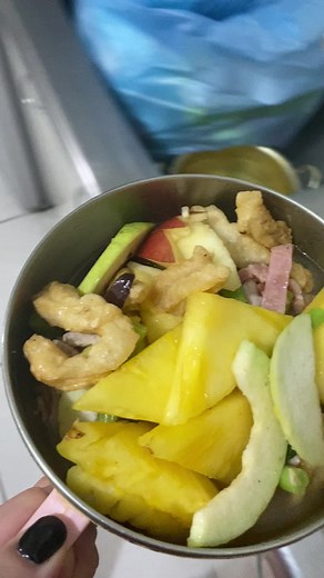 Enjoying a Feast: Black Pig Dining on Fruits