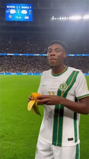 Soccer player eating mango