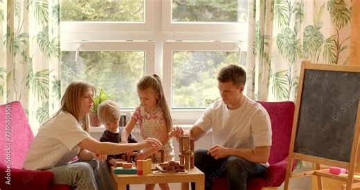 Learning Through Play: Playing with building blocks is highly educational activity for children, promoting cognitive development, spatial awareness, problem solving skills. Parents with kids indoor.