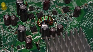 Detail on circuit board with microprocessors and capacitors. 4K UHD Video