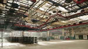 Conveyor with tires at the factory. Manufacture of tires. Tyre production machine conveyor. Large car tire factory. Tyre blanks in the workshop before being sent to the molding workshop.