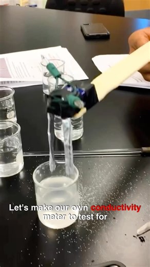 C̤̈ℍƎᗰᎥC̤̈ᗩℓ ƘᎥᗰ on Instagram: "A simple homemade conductivity meter explores how electricity travels through different solutions and reveal the hidden chemistry inside everyday substances. The setup uses a 9V battery, a holiday light, and aluminum foil acting as connected to two exposed probes that are placed into solutions. Pure water conducts electricity very poorly, but when acids, bases, or salts dissolve in water, they separate into charged particles called ions that allow electrical curre