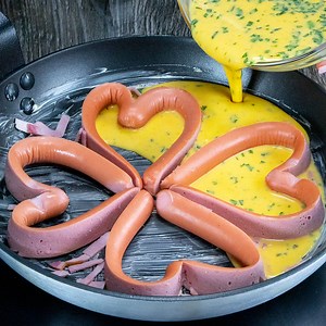 521K views · 12K reactions | How to make hearts using sausages without breaking them. Romantics’ omelet! Ingredients: sausages - 4 pieces eggs - 4 pieces salt - 8 g (0.29 oz) black pepper - 4 g (0.11 oz) sour cream - 50 g (1.76 oz) flour - 50 g (1.76 oz) cherry tomatoes - 100 g (3.5 oz) parsley - 7 g (0.25 oz) mozzarella - 60 g (2 oz) ham - 30 g (1 oz) Fry into the pan 10 min over low fire | Appetizing.tv | Facebook