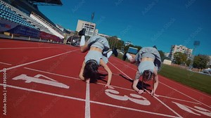 Two fiery women joyfully dancing on a stadium track. Slow motion shooting. Women cheerleaders in short skirts happily dancing on the running track. Two girls in bras seductively dancing together on a