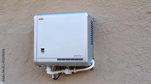 A mounted air conditioning unit on a wall, showcasing a modern design and focusing on functionality and energy efficiency.
