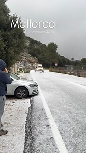 Snow was swallowing Mallorca island yesterday. Mallorca wakes up to a white chaos we never expected. The wind claws at the streets, waves crash like they’re trying to break into the coastline, and the sky feels heavy enough to fall. People rush for shelter while the palm trees bend and groan under the weight of a storm that simply doesn’t belong here. What was sunshine yesterday is a blizzard today, and the whole island feels like it’s holding its breath. If you’re outside right now… stay safe. 