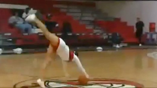 Cheerleader nets half-court forward flip basketball shot – video
