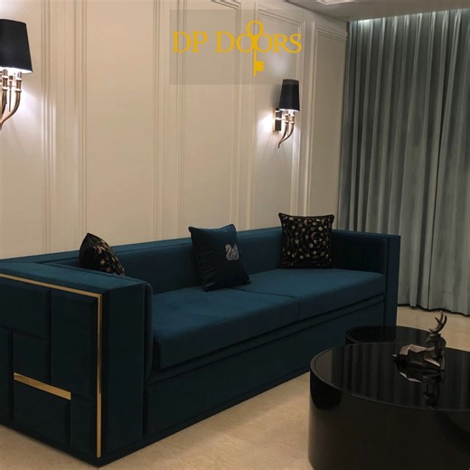 DP Doors on Instagram: "A beautifully managed small living space with a modern and elegant design. A teal upholstered sofa paired with floor-to-ceiling curtains adds depth and warmth to the room. At the center, a round black center table with two additional nested tables creates a stylish yet space-saving focal point. A wall-mounted TV with a sleek white console keeps the area uncluttered, while neutral flooring and soft lighting enhance the calm, luxurious feel of this compact space. D P Woodte