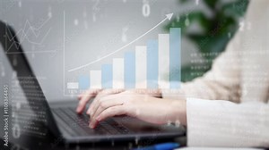 Hands type on a laptop keyboard with a superimposed upward-trending bar graph and percentage scale, suggesting business growth, data analysis, or financial success.