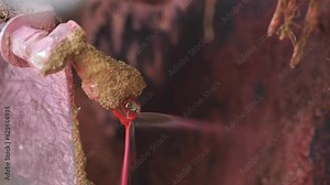 Potato planter equipment close-up. Spraying red liquid. Cleaning, disinfection