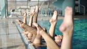 Group of young woman exercising and performing synchronized swimming