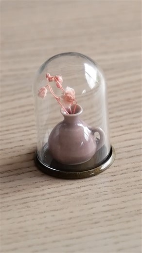 A tiny pot inside a glass dome is pure charm