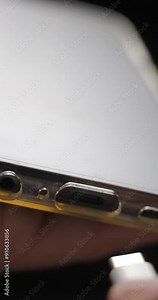 USB-C cable macro plugin to smartphone slow motion, vertical view