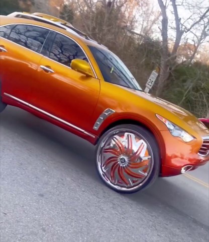 Candy gold Infiniti QX70 on 32" DUB floaters skating