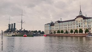 View from the water of the historic cruiser Aurora and the Nakhimov Naval School in the early cloudy morning