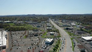4K Aerial Drone footage of industrial shopping centers and strip malls in Middletown New York (Hudson valley). Highways (17) and traffics can be seen with mountains in the background. Clip 6 of 22