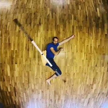 Circus Artist Performs Foot Juggling With Bo Staff - 1240605
