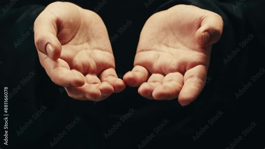 Silver batteries AA and AAA in hands on black background close-up. Double-A battery is a standard size single cell cylindrical dry battery. Batteries are common in portable electronic devices. An AA