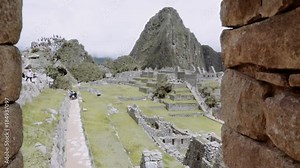 Aerial view through stone window of the archeological site of Machu Picchu, Peru.