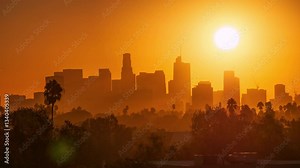 Sunrise sun raising over city skyline. Zoom in on iconic downtown Los Angeles skyline buildings. Timelapse.