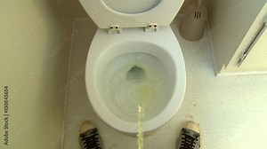 Pee Splatter, Take 1 of 2. Funny point of view (POV) shot of a man standing and peeing into a toilet with lots of splatter. Take 1 of 2.