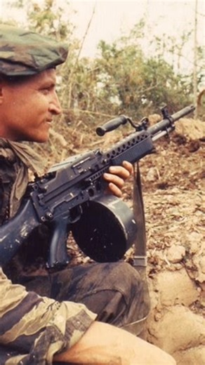 A tiger stripe clad SEAL team member in the Mekong Delta keeps guard with a Stoner 63A Commando during Operation Bold Dragon III. PH1 L. R. Robinson / The National Archives Photo taken: March 1968 | Lily's
