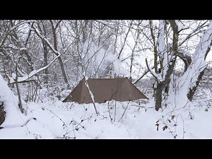 hiding in winter hot tent from the rain , bushcraft trip in canvas shelter