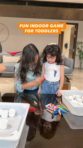 By Shraddha ✨! Parenting & Toddler Play on Instagram: "🎯 Peg Challenge! Clip some pegs on your toddler’s clothes and place a tub or basket in front of them. Ready, set… GO! Let them unclip the pegs one by one and drop them into the tub. See who finishes first — you or your little one? 😉 ✨ Benefits of this activity: • Strengthens fine motor skills and finger grip • Builds hand-eye coordination • Encourages focus and speed • Boosts problem-solving and independence • Perfect screen-free play idea