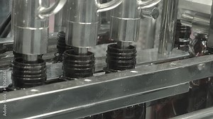 Bottles filling automation machine in modern factory. Technology demonstration of filling and capping bottles in the industry. Inspection of Vials For Defects. Pharmaceutical and drink Manufacturing.