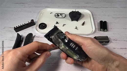 Disassembling a men's electric wireless razor and replacing old batteries - step 7 of 10, part of a series: removing from the handle of the plastic front part and the electronic board with the batteri