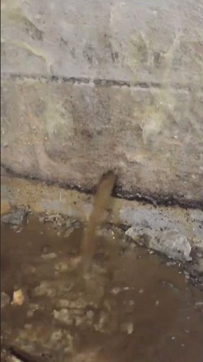 Weep holes drilled in cinderblock walls