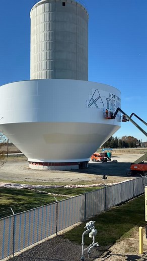 Before the tank touches the sky: The painting crew adds logos, starting with a stencil, marking the outline, then hand painting the drop and letters. 💧🎨 | Northwestern Water & Sewer District