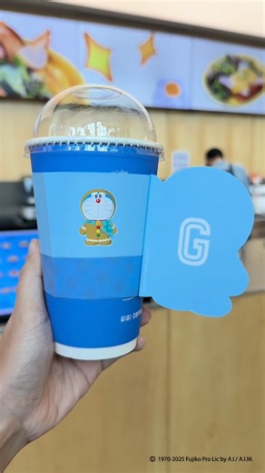 GIGI COFFEE on Instagram: "Your favorite drink just got a major upgrade! 💙 Meet the limited-edition Doraemon Cup Sleeve! Now every sip comes with a side of childhood memory 🥹 Just order our Doraemon Series drink and the sleeve is yours!"