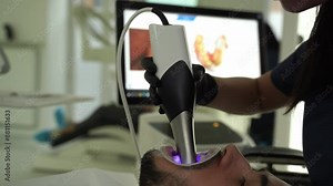 Dental scanner applying in stomatology clinic 4k video. Assessment of patient teeth condition with dental hardware.