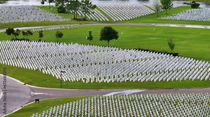 Aerial view of large Sarasota National Cemetery with rows of white tomb stones on green grass. Memorial Day concept